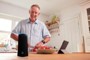 man in kitchen with WellBe medical alert PLUS system