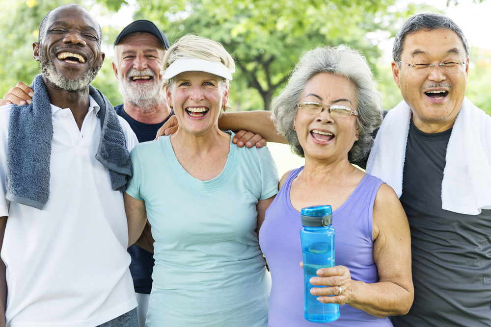  A group of senior friends smiles after exercising, knowing their HandsFreeHealth smartwatch for seniors keeps them safe. 