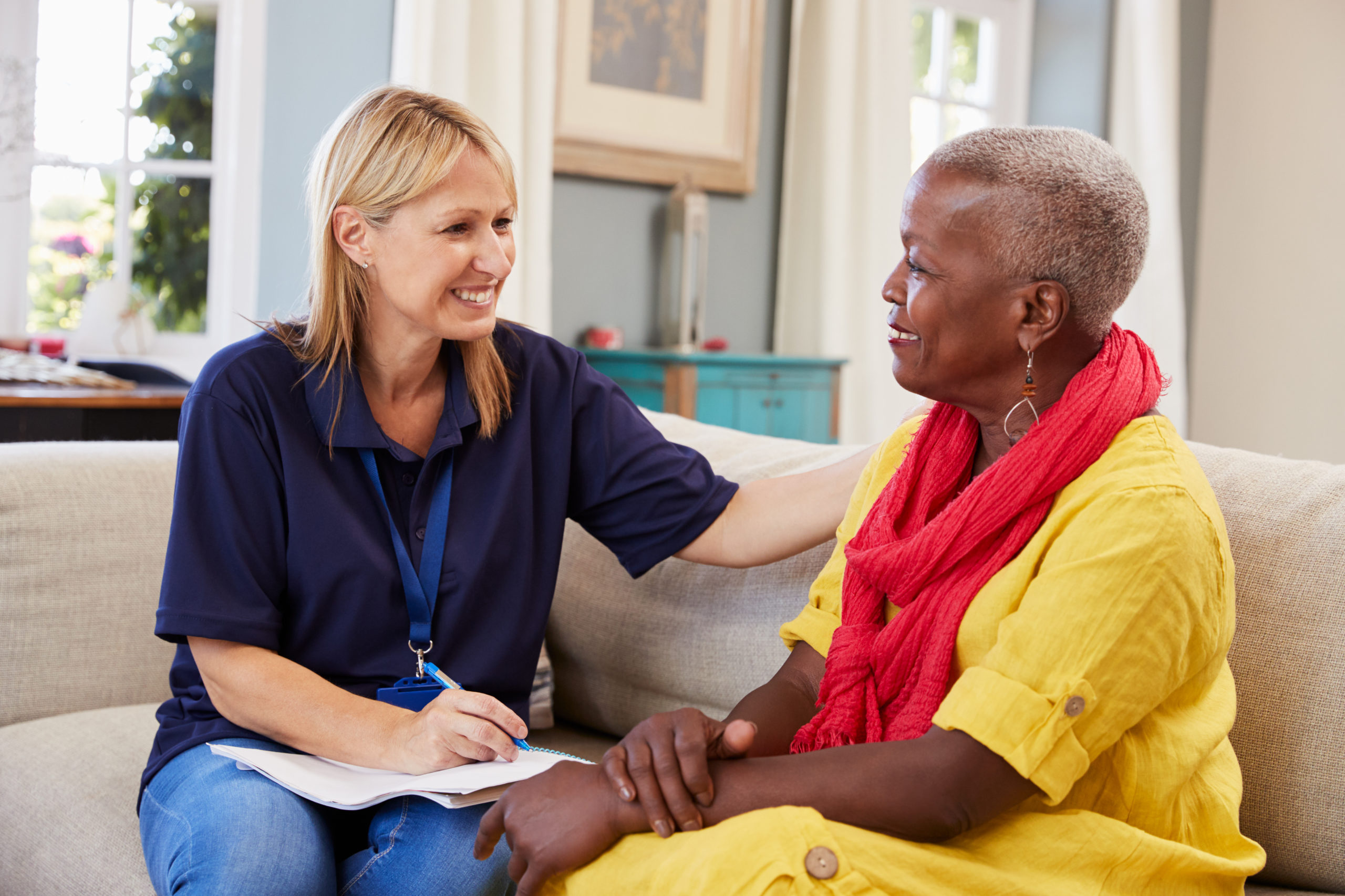 A home health provider visits a senior woman at home. 