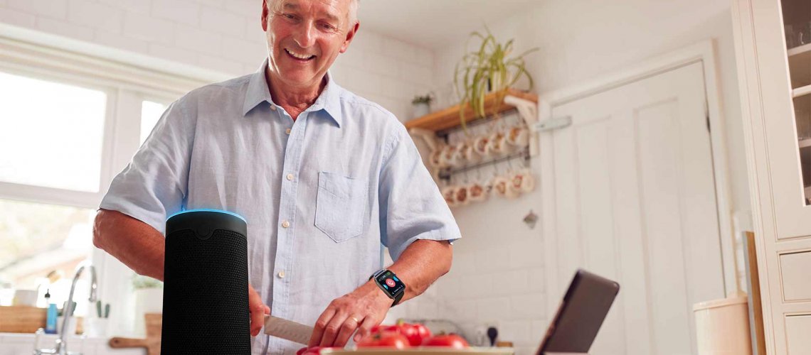 man in kitchen with WellBe medical alert PLUS system