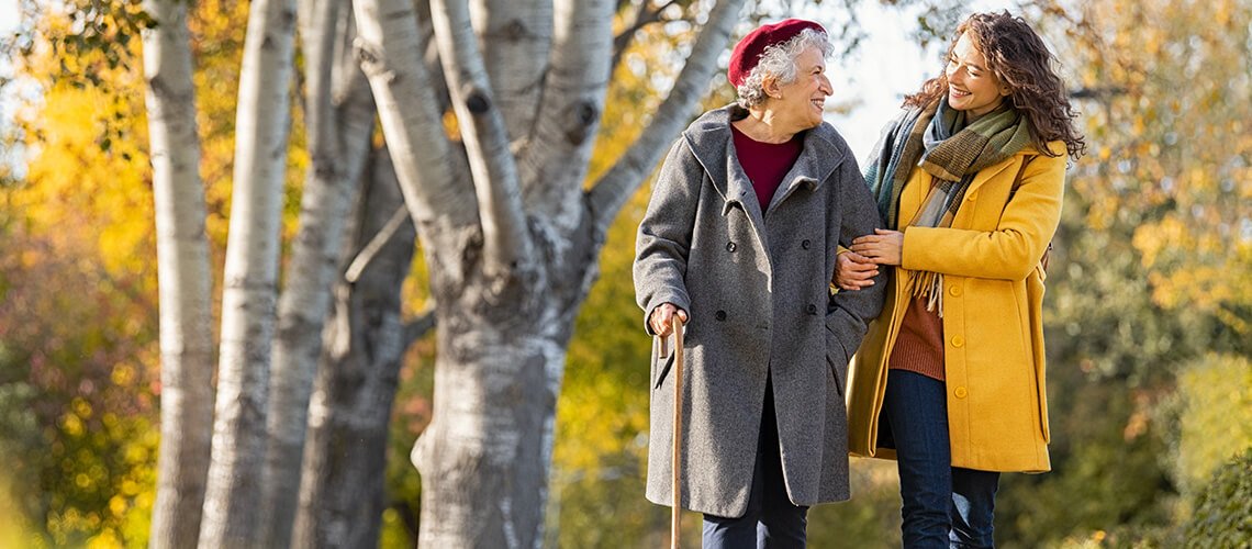 Mother and daughter take a walk together outdoors.
